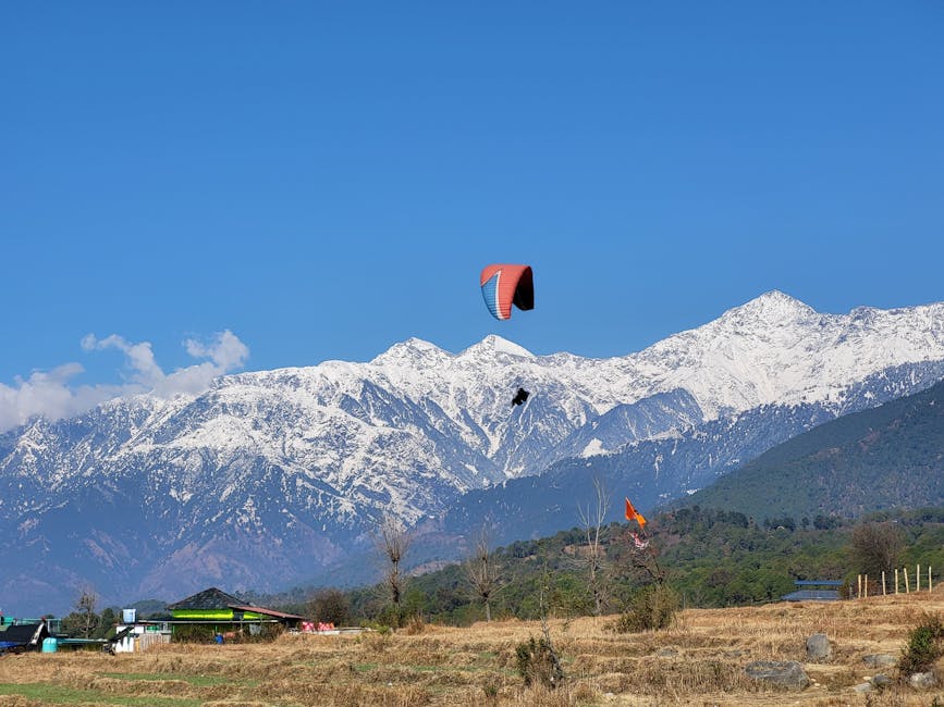 Paragliding over snowy mountains of Bir