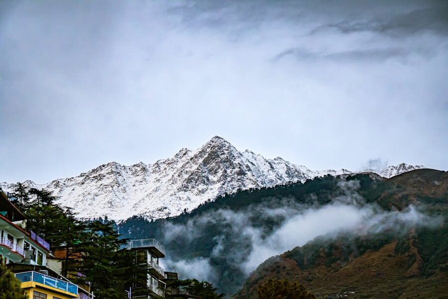 Snow-capped mountains with clouds in Dharamshala