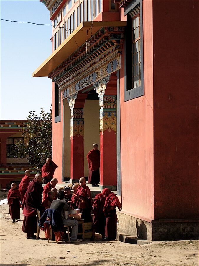 Tibetan monks walking through the Bir Tibetan Colony