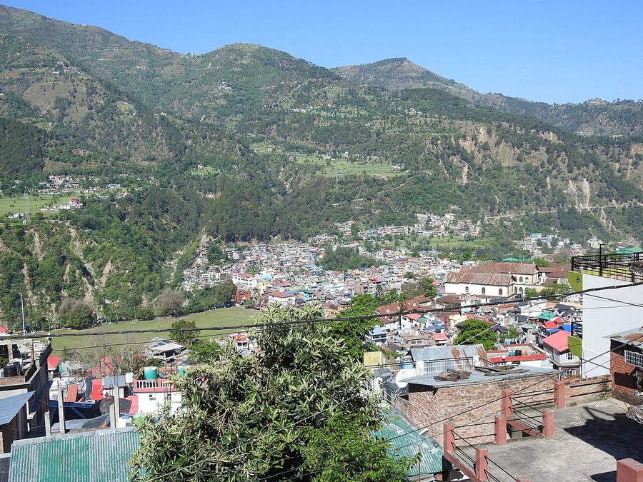 The town of Chamba in Himachal Pradesh viewed from a hillside with the Ravi River running through the valley.