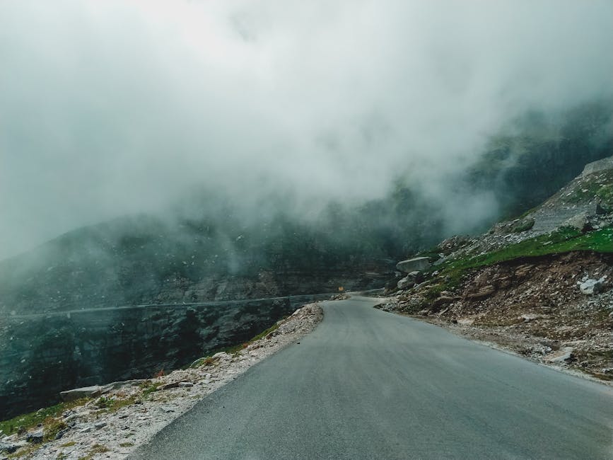 Fog-covered mountain road in Manali, illustrating monsoon-season visibility on the Delhi-Manali run