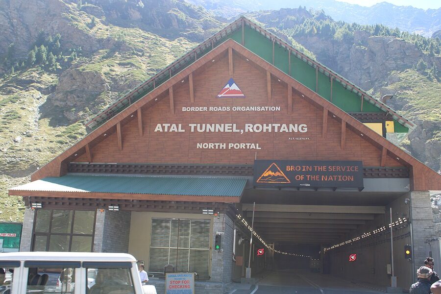 Road climbing from Manali to Rohtang Pass through pine forest