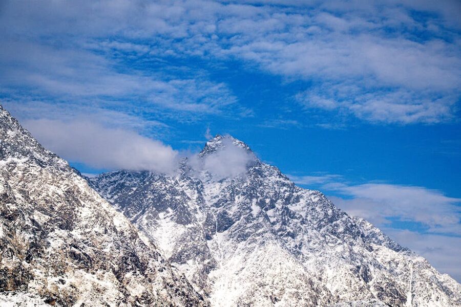 Snow-capped Himalayan peaks under a blue sky in Dharamshala, Himachal Pradesh.