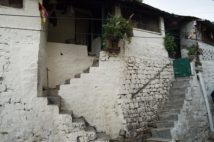 McLeod Ganj town centre in Dharamshala with Tibetan flags and prayer wheels.