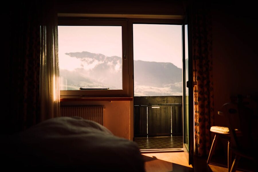 Wooden cabin interior with bed and mountain view