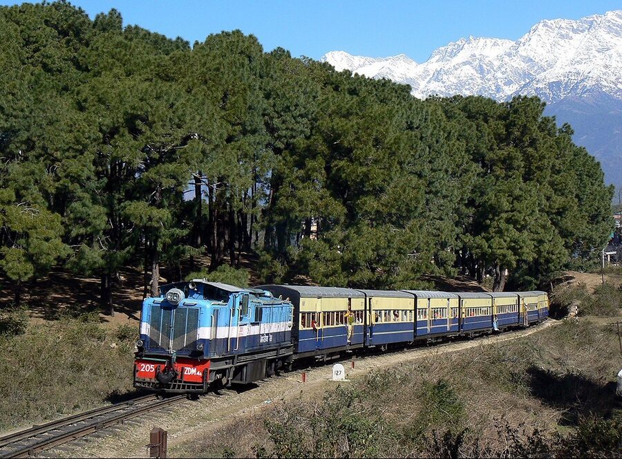 Kangra Valley narrow-gauge railway train running through the hills