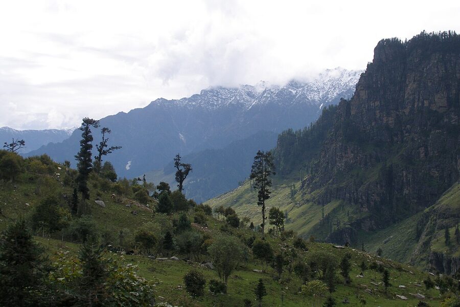 Snow-clad peaks rising over forested slopes in the Kullu Valley
