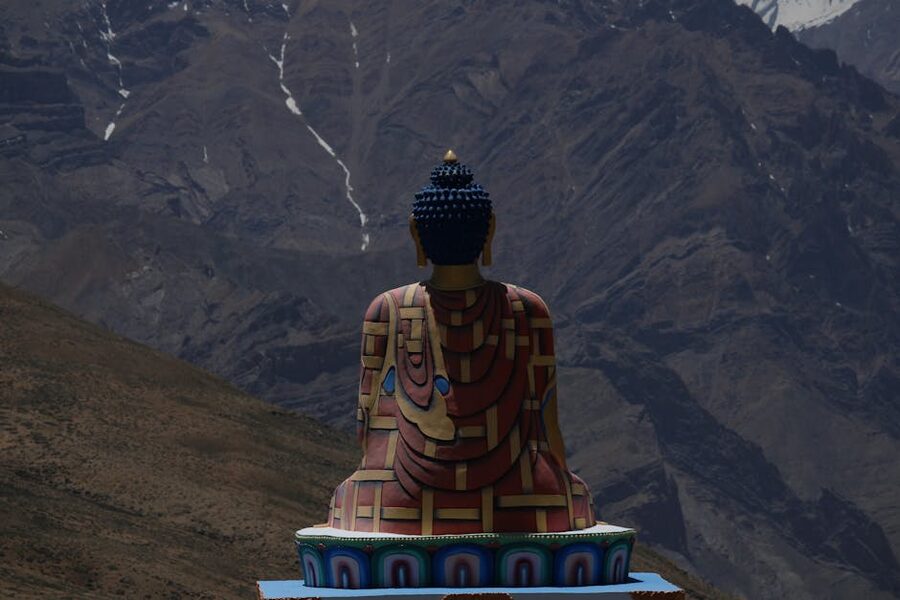 The seated Buddha statue at Langza village overlooking the Spiti Valley peaks.
