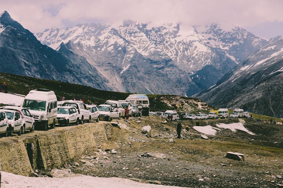 Vehicles lined up on the snowy mountain road near Rohtang Pass, Himachal Pradesh.