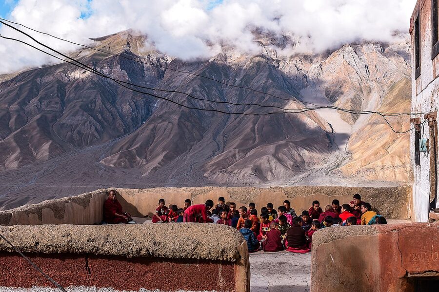 Young Buddhist novice monks praying before breakfast at Key Monastery, Spiti Valley.