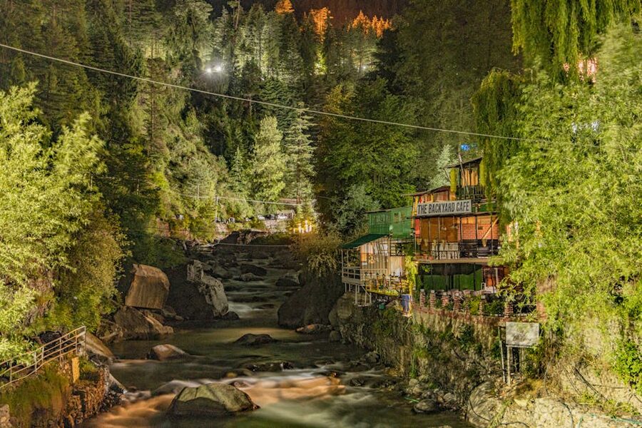 Night view of the Beas in Old Manali with riverside cafe lights