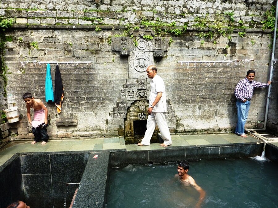 Stone bathing tank fed by sulphur hot springs at Vashisht near Manali