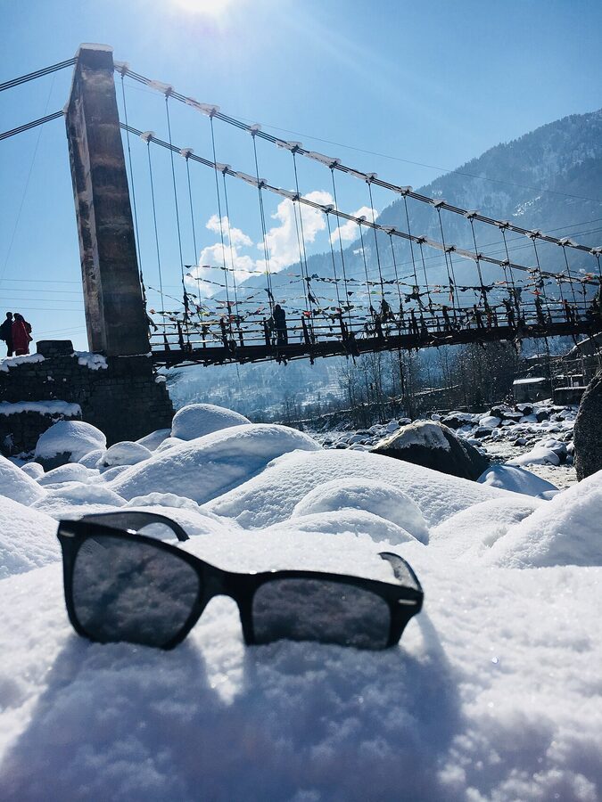 Heavy snowfall covering the rooftops and deodars of Manali in winter, Himachal Pradesh.