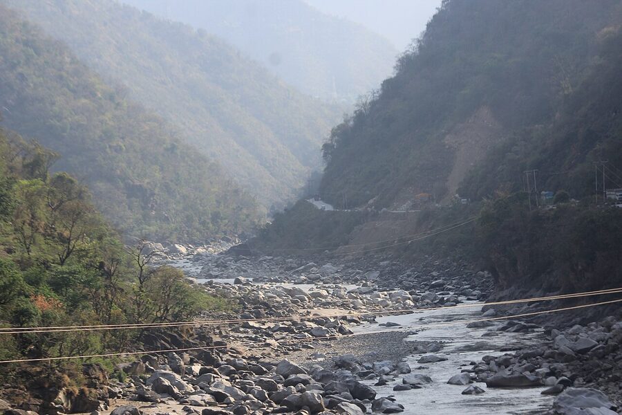 The Beas river flowing through Mandi, Himachal Pradesh, with steep wooded banks.