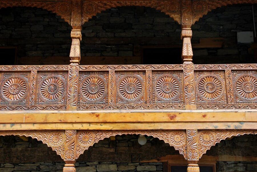 Carved Kath Kuni woodwork detail on a doorframe at Naggar Castle.