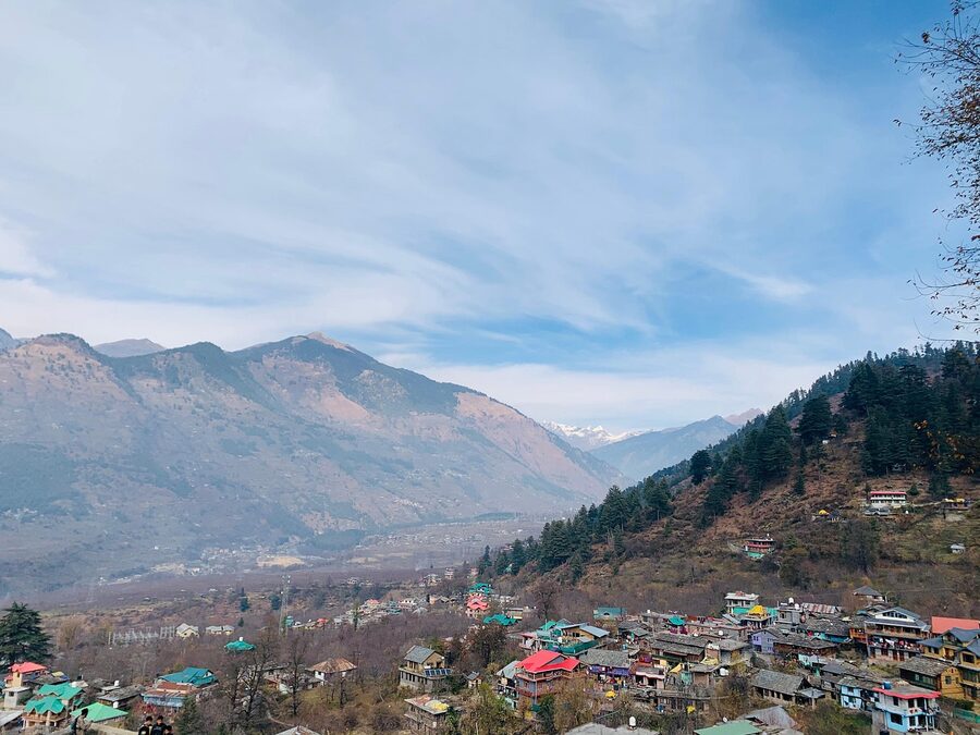 Naggar village rooftops with the Pir Panjal range visible in the background, Himachal Pradesh.