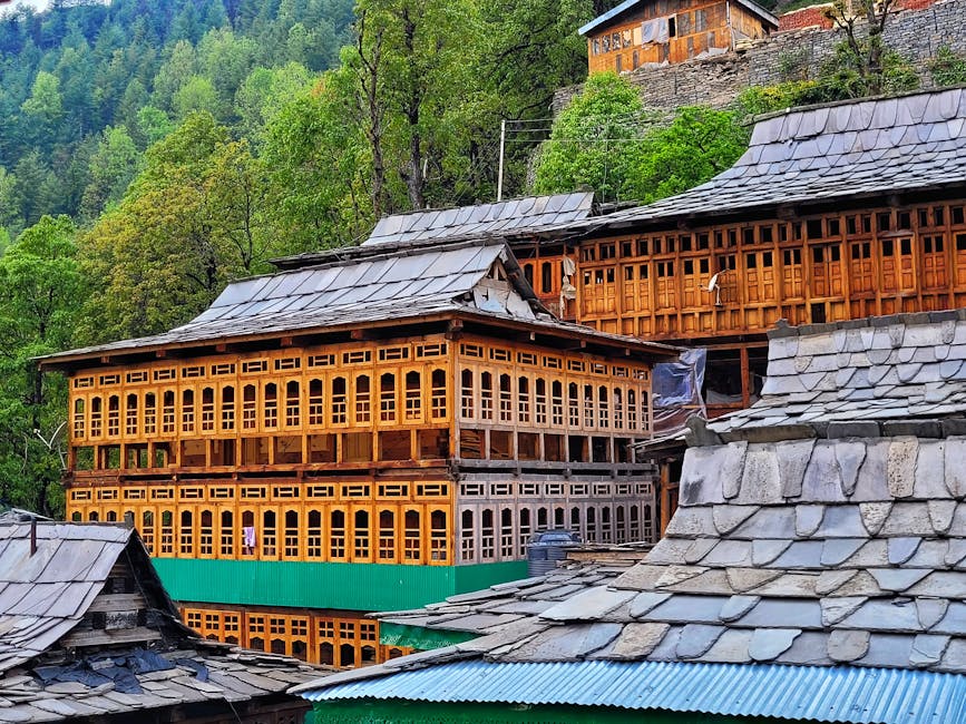 Wooden village buildings on the Naggar ridge with carved balconies.