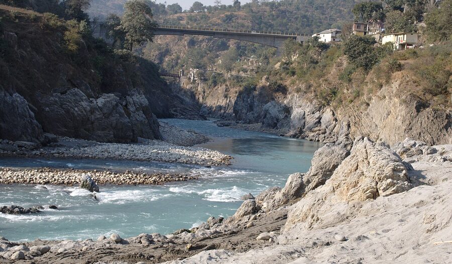 Tattapani hot springs on the bank of the Sutlej River, with traditional sulphur pools at river level.