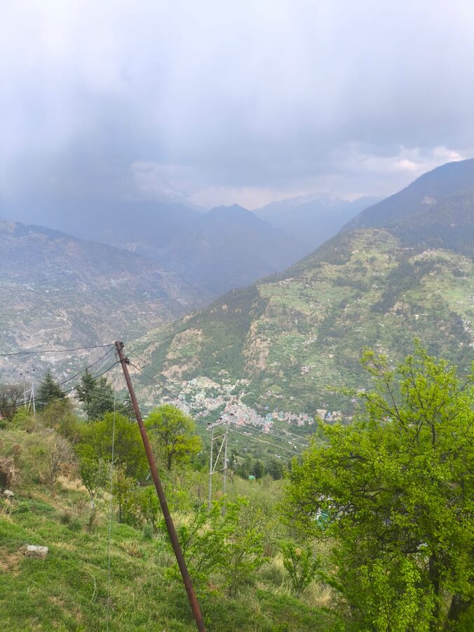 Banjar town in Kullu district, Himachal Pradesh, with Himalayan mountain backdrop