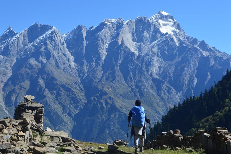 Trekker against rugged Himachal peaks