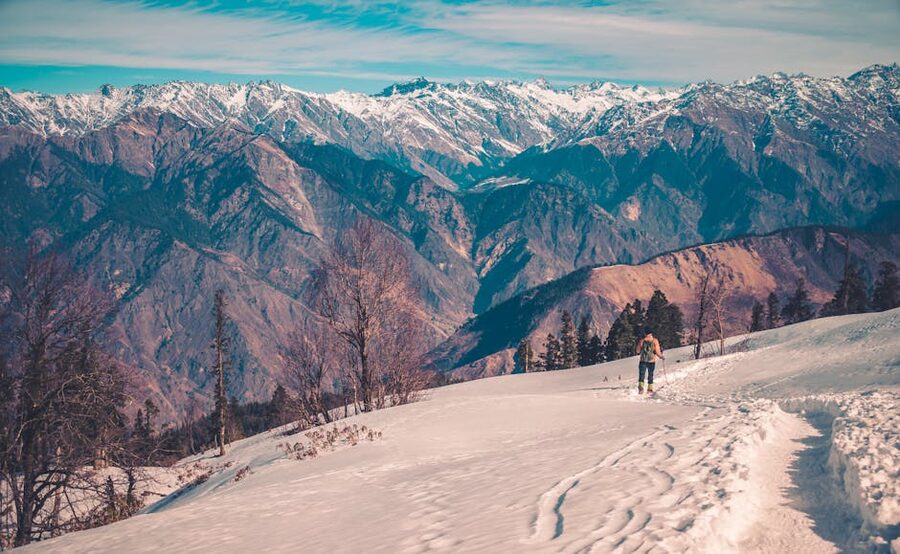 Trekker in snow on Himalayan high-altitude terrain