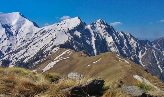 Great Himalayan National Park landscape with high snow-covered ridges.